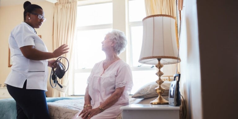 Elderly Woman with Nurse in Assisted Living Facility