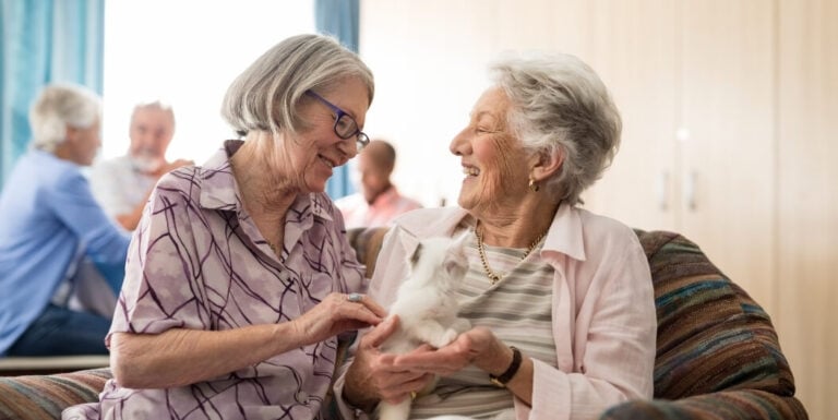Elderly Women Bonding over Kitten Visit at Memory Care Facility